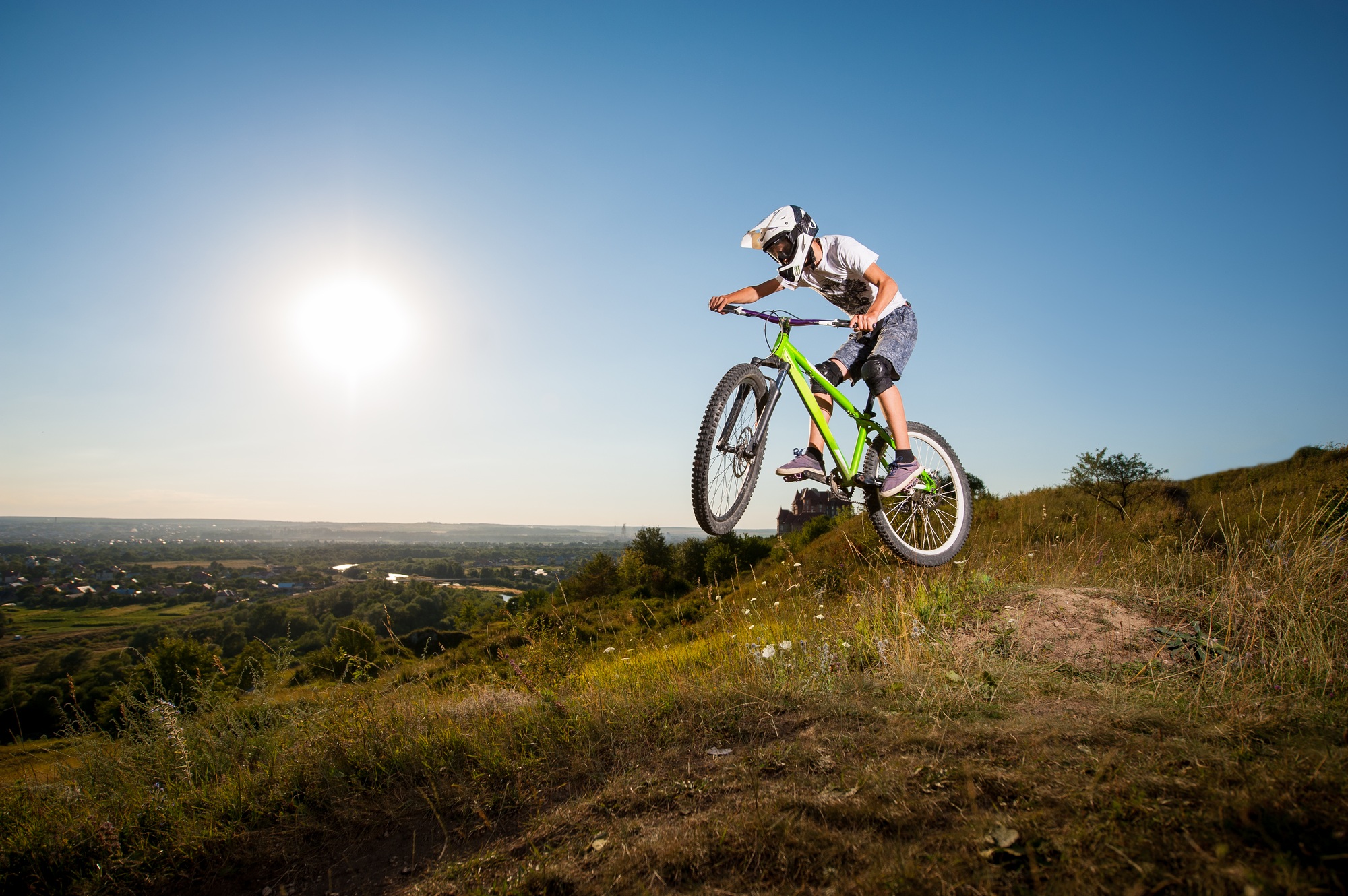 Cyclist riding downhill on mountain bike on the hill